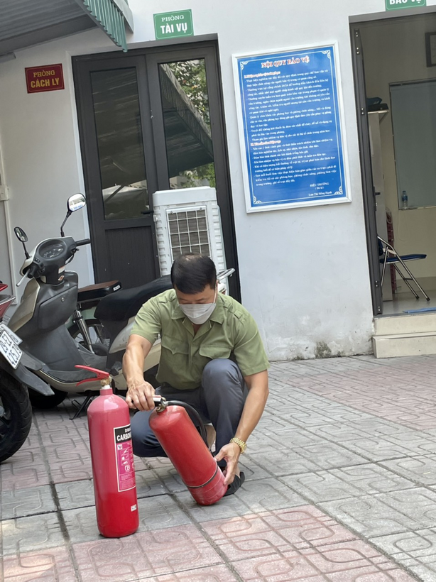 A person sitting on a red fire hydrant
Description automatically generated