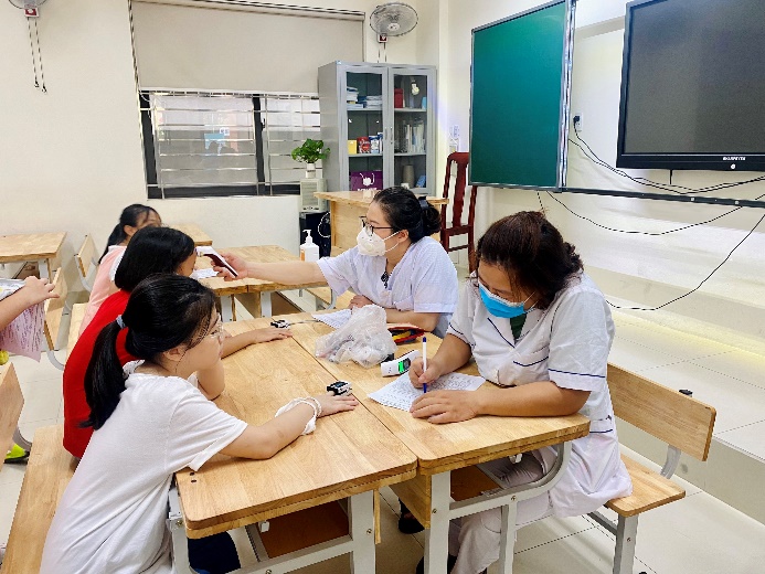 A picture containing text, person, sitting, indoor

Description automatically generated