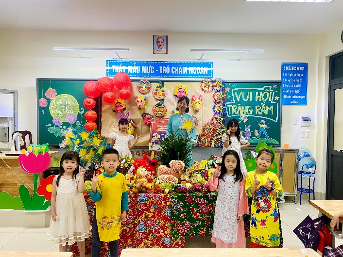 A group of children posing for a photo in front of a decorated wall

Description automatically generated with low confidence