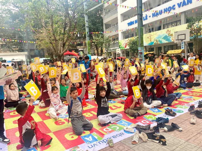 A group of people sitting on the ground holding signs
Description automatically generated with low confidence