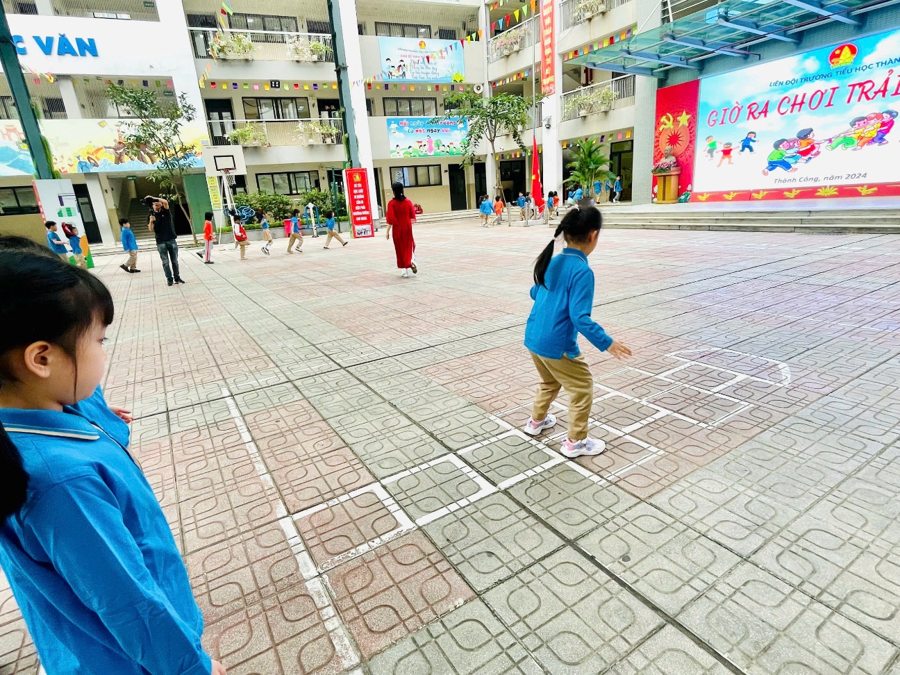A group of kids playing hopscotch
Description automatically generated