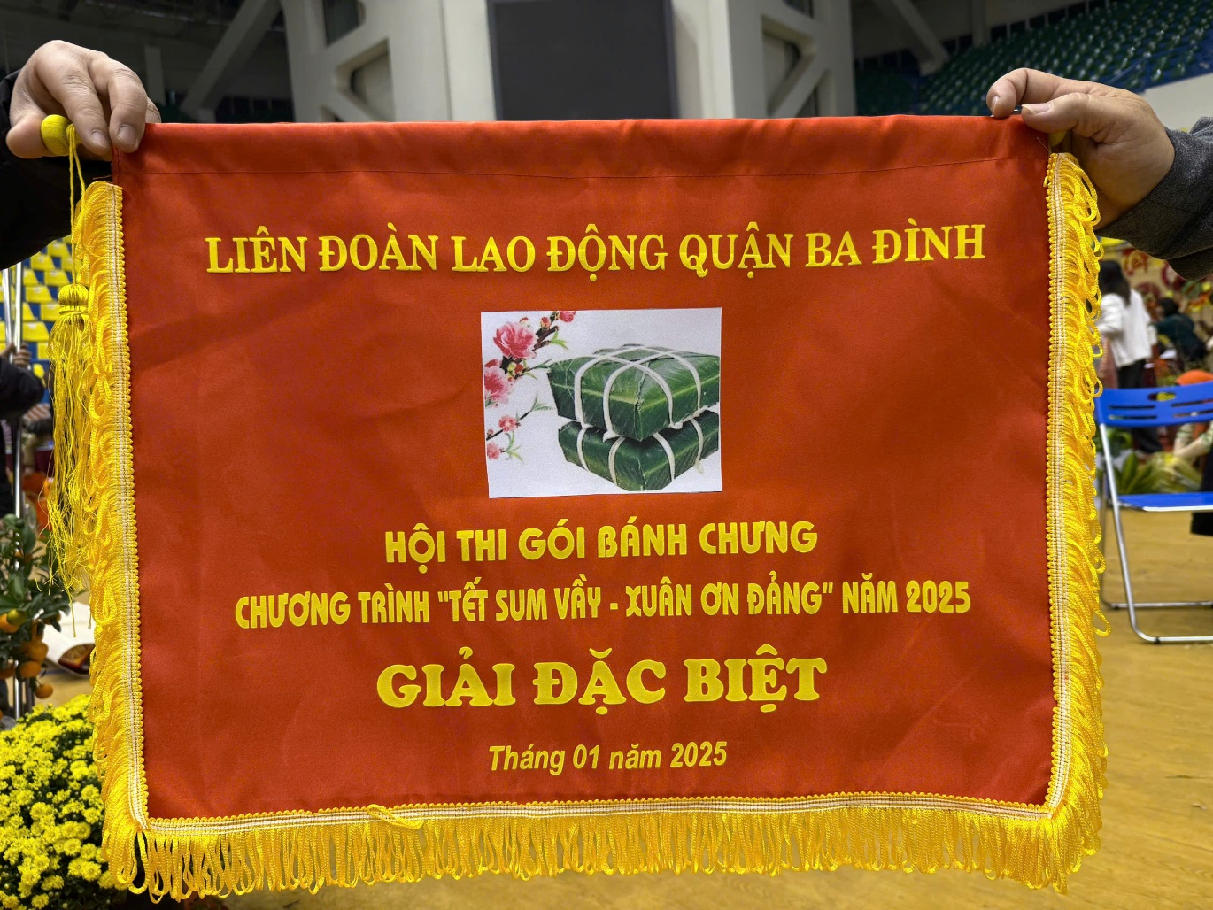 A person holding a banner
Description automatically generated