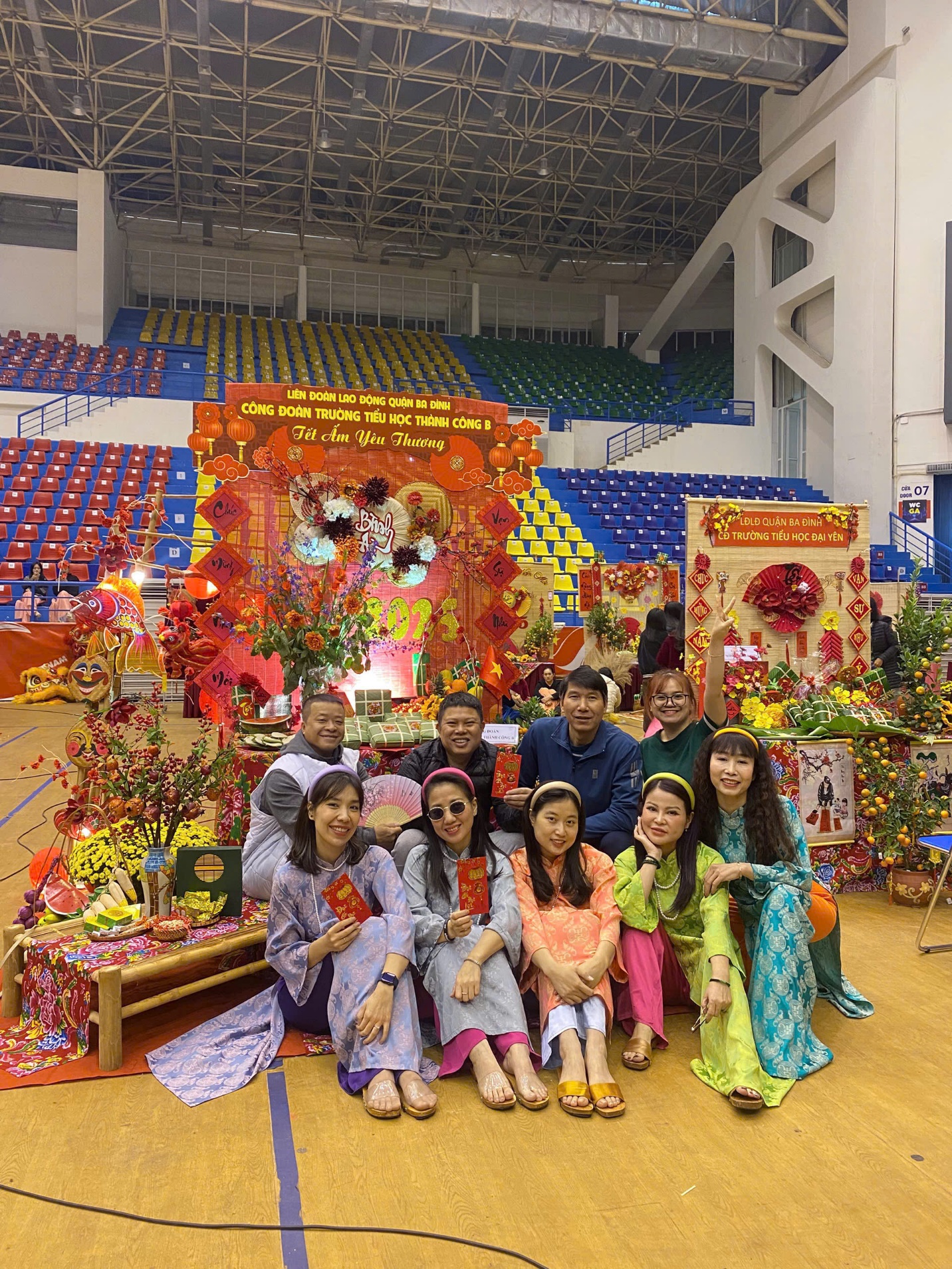 A group of people posing for a photo in a sports arena
Description automatically generated