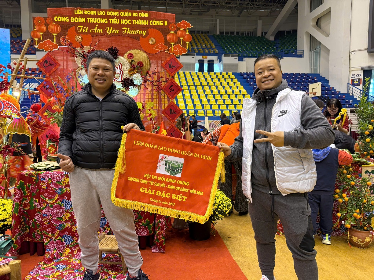 Two men holding a flag
Description automatically generated