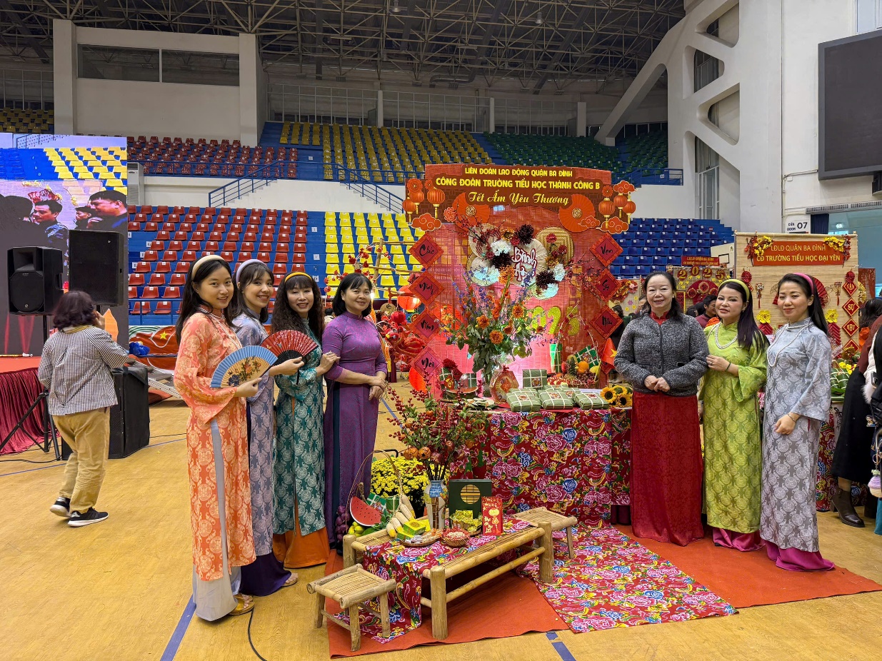 A group of women standing in front of a table with colorful decorations
Description automatically generated