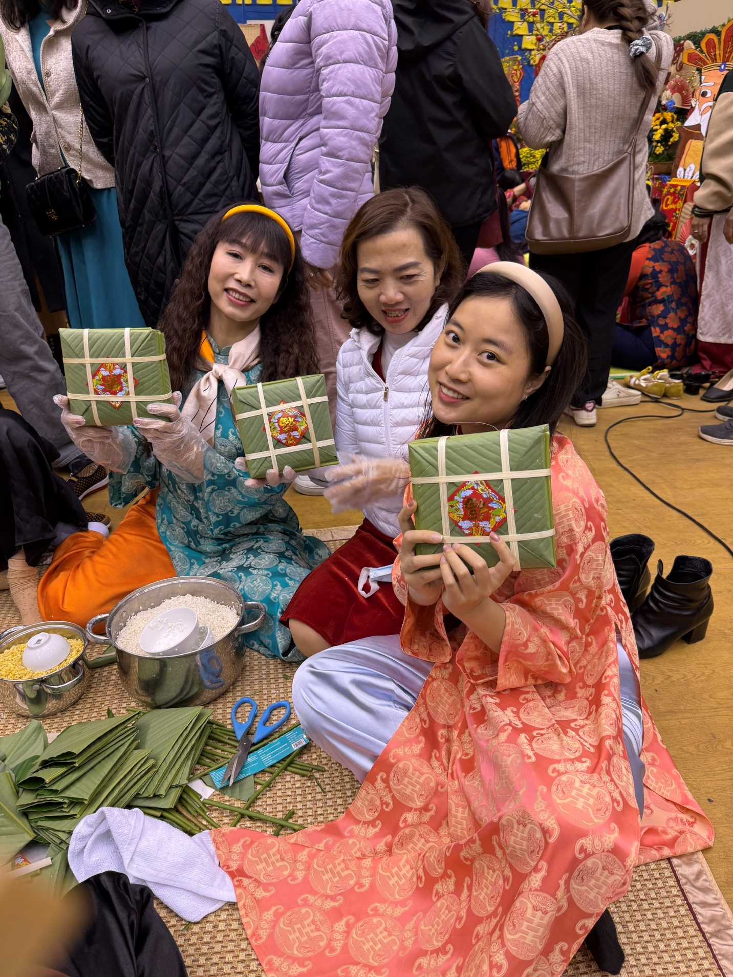 A group of women holding small wrapped presents
Description automatically generated