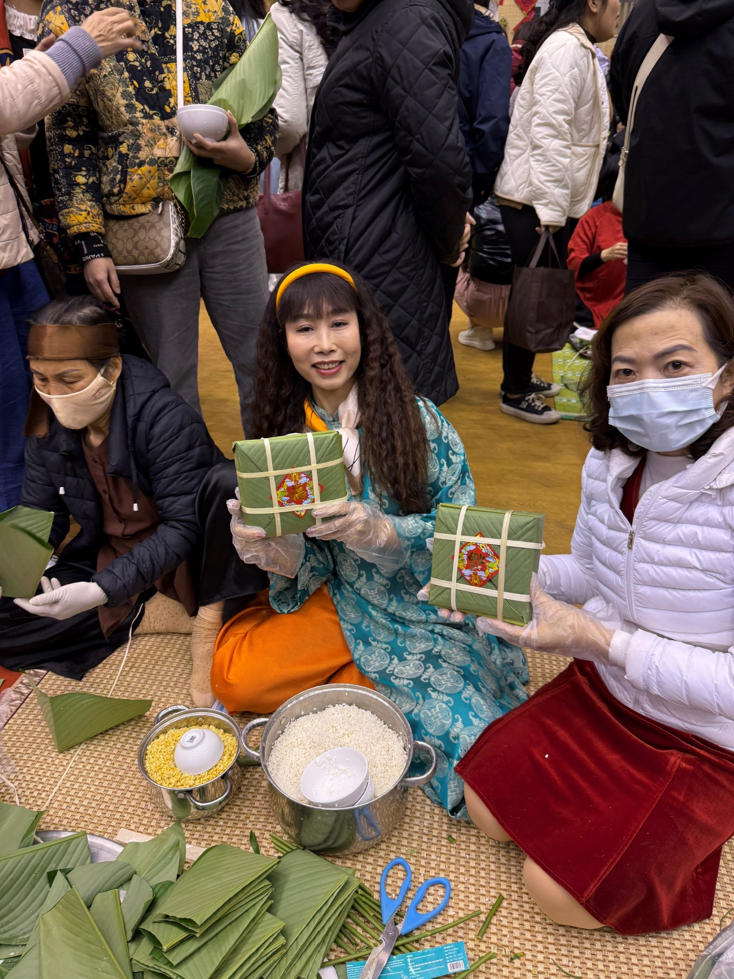 A group of people holding wrapped presents
Description automatically generated