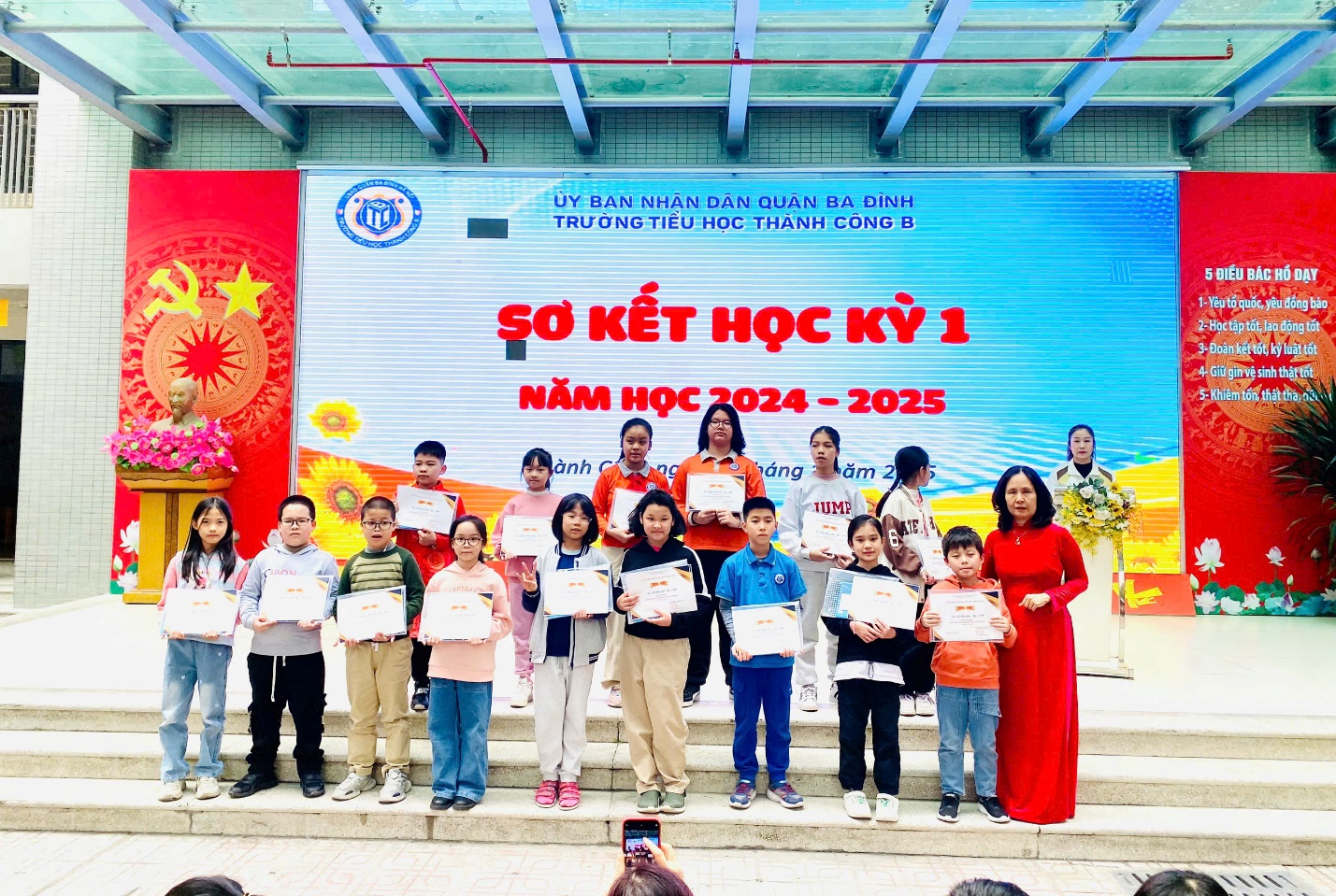 A group of people standing on stairs holding signs

Description automatically generated