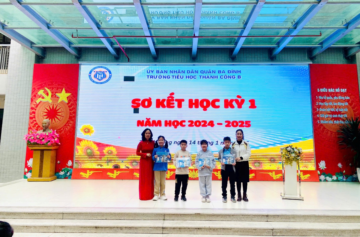 A group of people standing on a stage

Description automatically generated