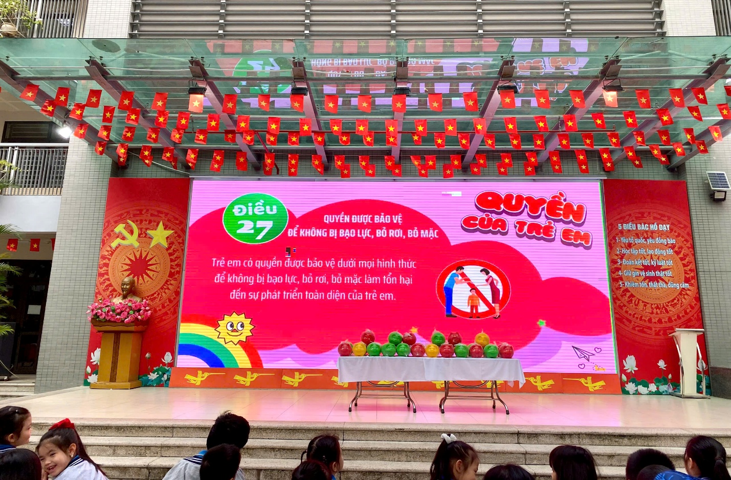 A stage with a table and balloons on it
AI-generated content may be incorrect.