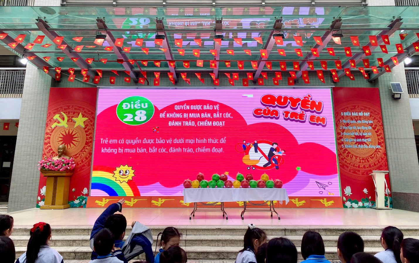 A stage with a large sign and a group of people
AI-generated content may be incorrect.