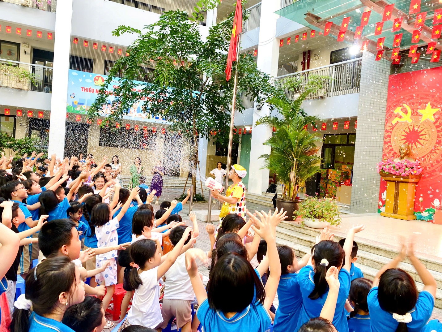 A group of kids raising their hands
Description automatically generated