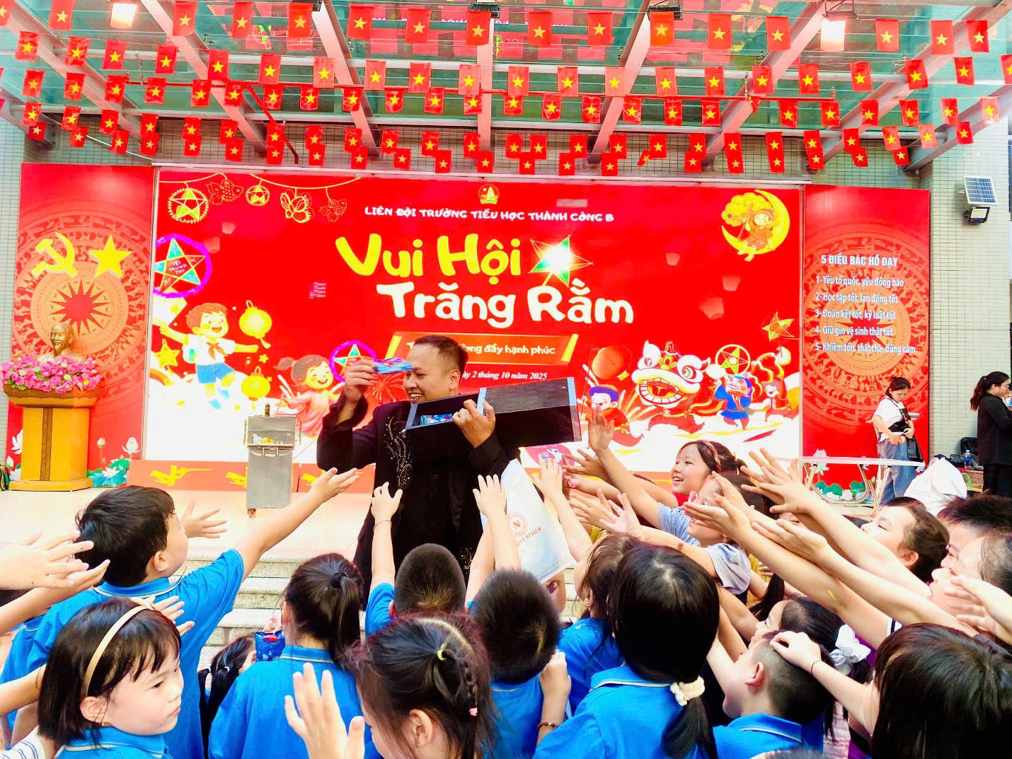 A person in a black robe with a crowd of people raising their hands
Description automatically generated