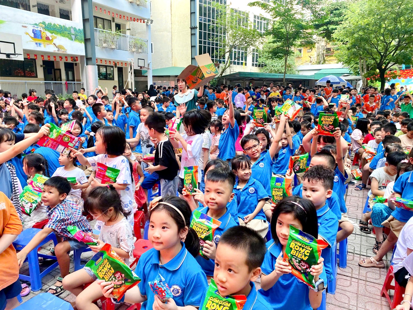 A group of children in blue shirts
Description automatically generated