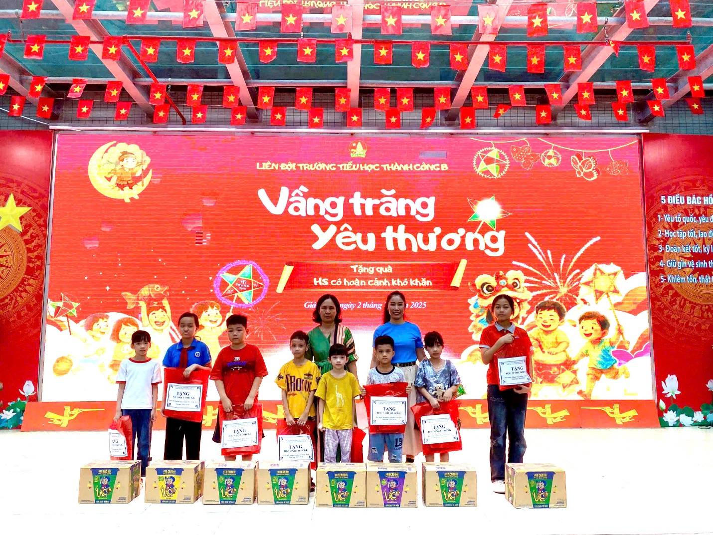 A group of children standing on a stage
Description automatically generated
