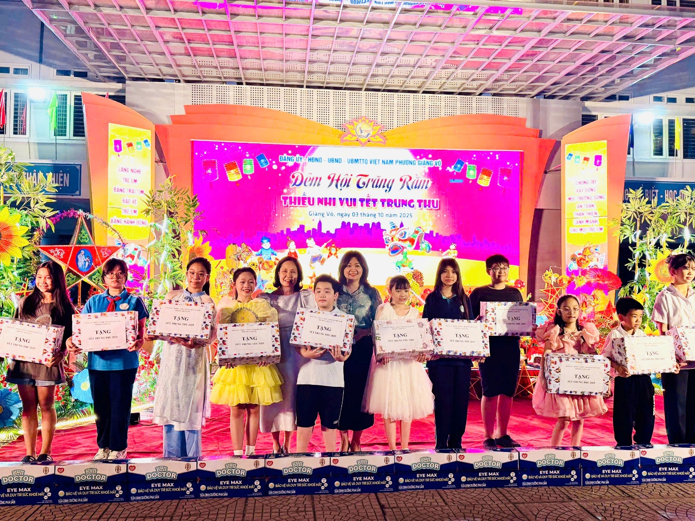 A group of people holding signs
Description automatically generated