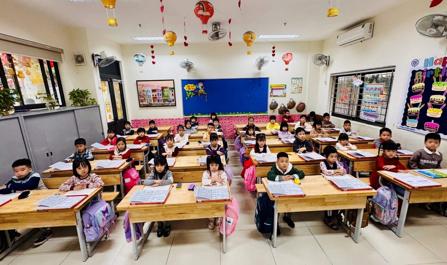 A group of children sitting at desks in a classroom
AI-generated content may be incorrect.