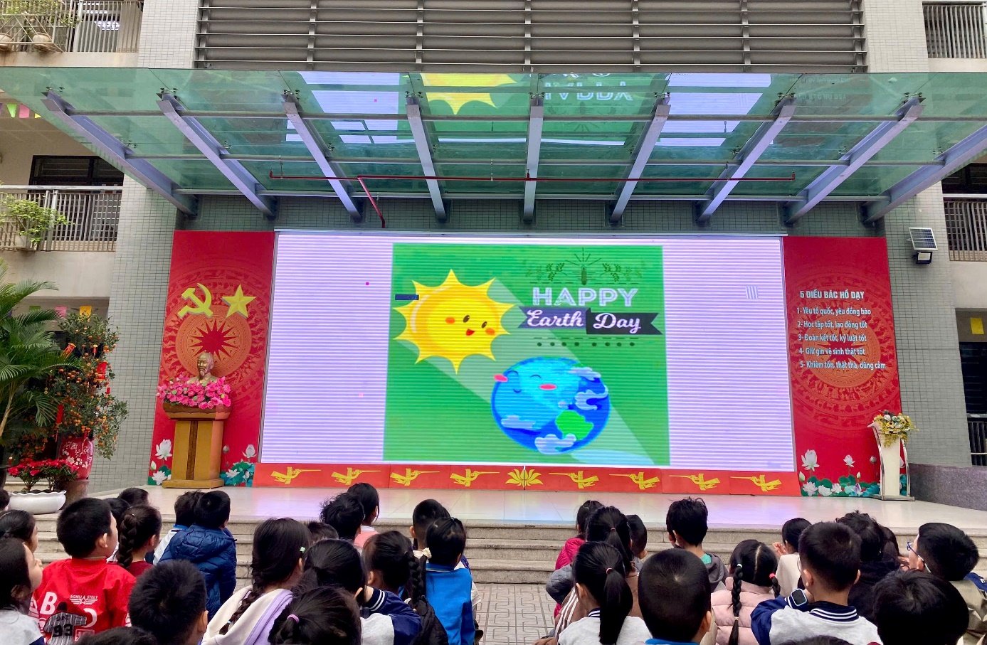 A group of children in front of a screen
Description automatically generated