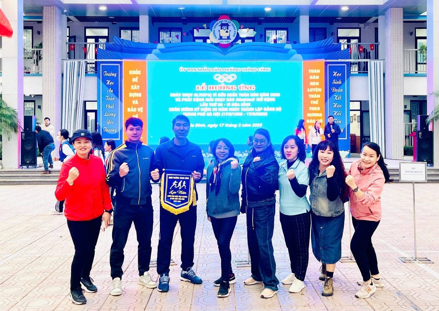 A group of people posing for a photo
Description automatically generated