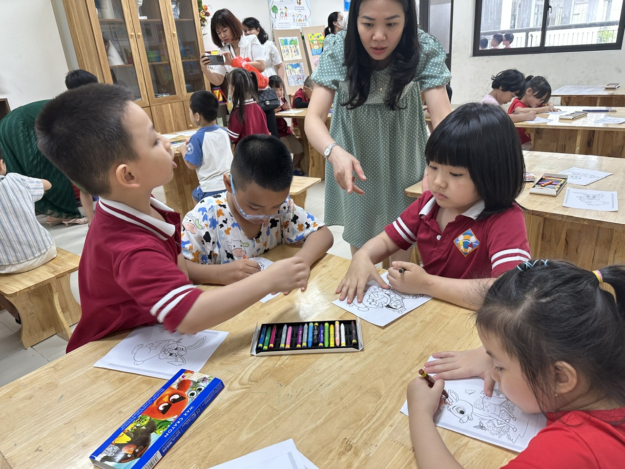 A group of children sitting at a table

AI-generated content may be incorrect.