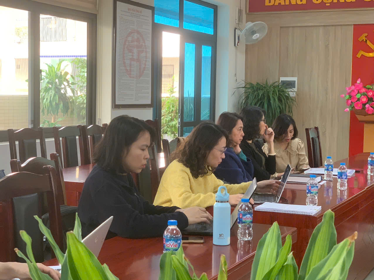 A group of women sitting at a table with laptops
AI-generated content may be incorrect.