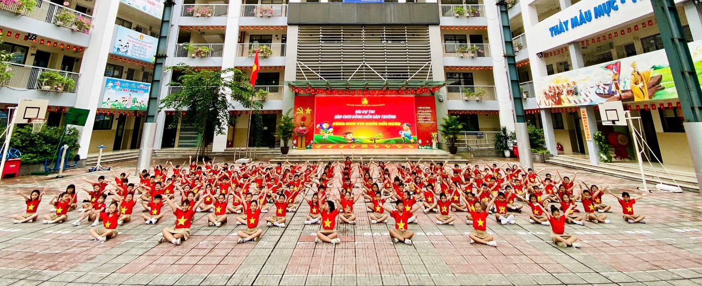 A group of people in red shirts
Description automatically generated