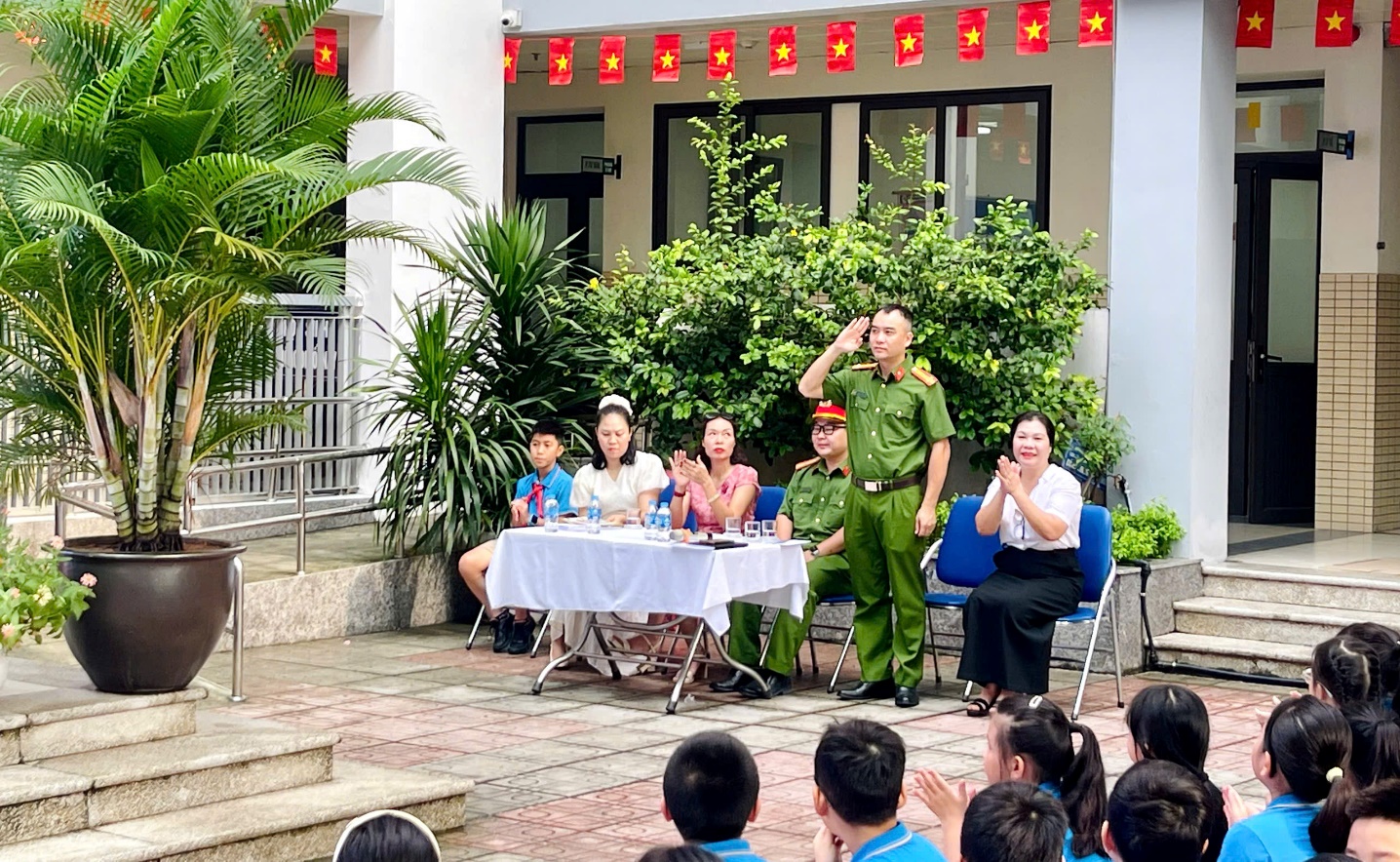 A group of people sitting in chairs in front of a building
Description automatically generated